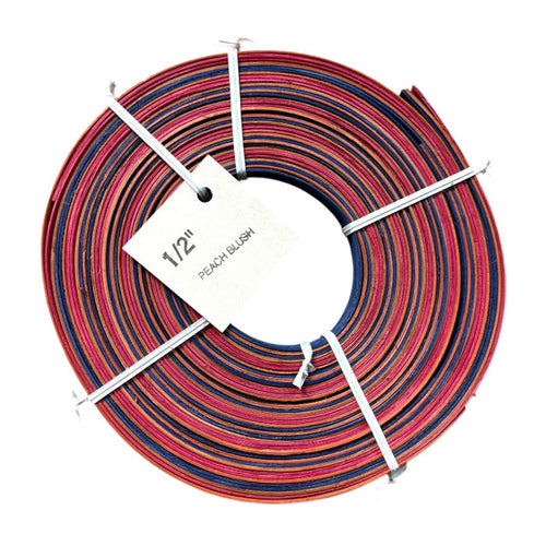 Coil of 1/2" Peach Blush Dyed Flat Reed with product tag.