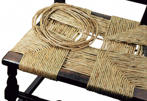 Pre Twisted Natural Rush from HH Perkins woven on a chair in the four corner pattern.