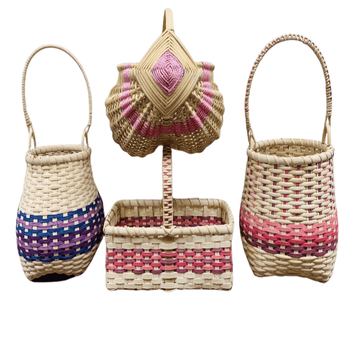 Four different styles of basket weaving kits showing the finished product. The Shaker Cathead Kit with purple reed, the market basket kit with pink reed, the Shaker Cathead kit with pink reeds, and the egg basket kit with pink macrame.