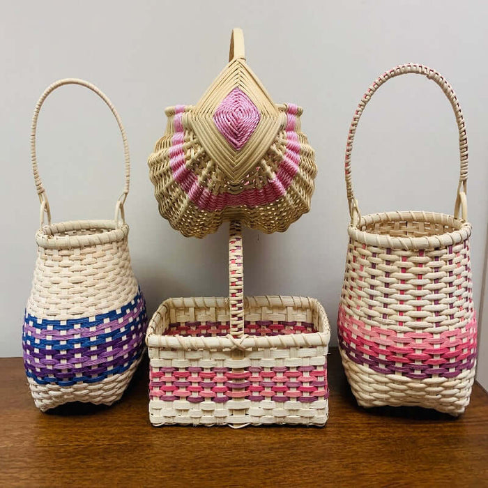 Four finished basket kits with the egg basket resting on top of the market basket. Two shaker cathead kits with different styles are on the side.
