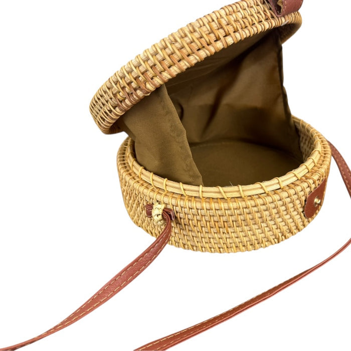 Open artisan rattan canteen handbag with nylon lining and leather strap, showcasing unique handwoven design.