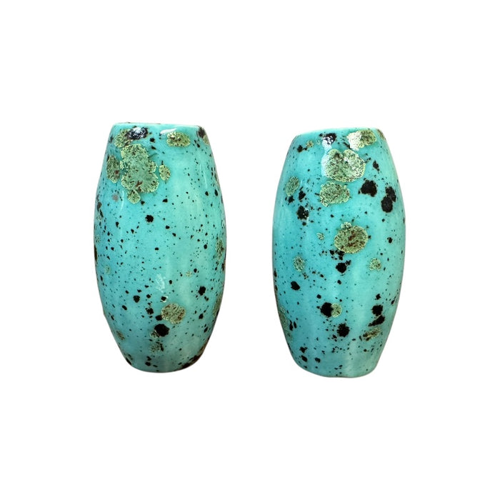 Pair of turquoise ceramic basket handles with speckled pattern on a white background