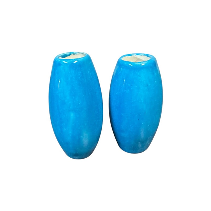 Two blue ceramic basket handles on a white background