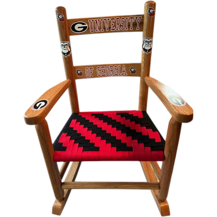 A customized completed Shaker Rocker chair with University of Georgia emblems and Red and Black Shaker Tape woven on the seat in a zig zag pattern.