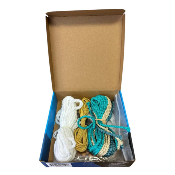 Dream Catcher Kit opened showing all of the materials inside including beads, cords and directions.