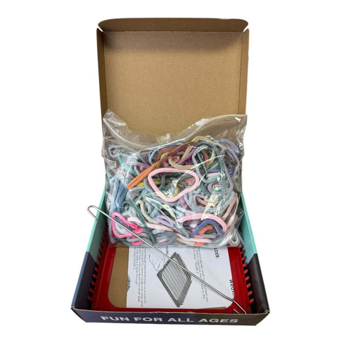 The metal weaving stand with box open showing the materials that are included in the DIY kit.