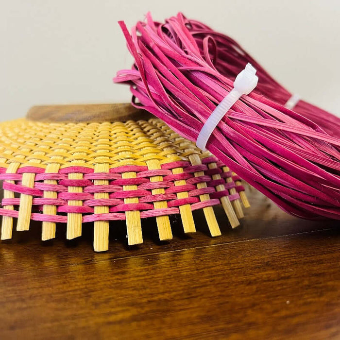 Dyed Hamburg Cane with started Nantucket Basket showing how you weave the colored cane over and under the basket staves.