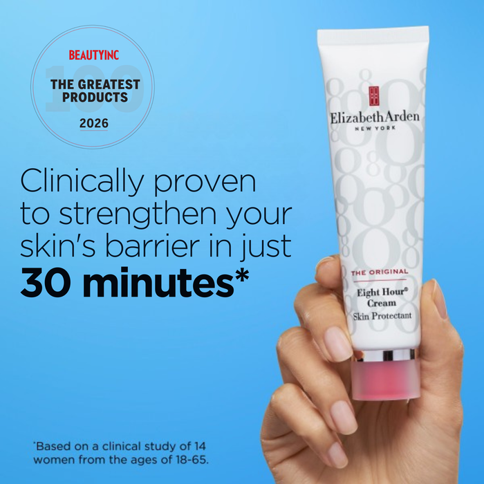 Elizabeth Arden Eight Hour Cream held by a hand with promotional text on a blue background