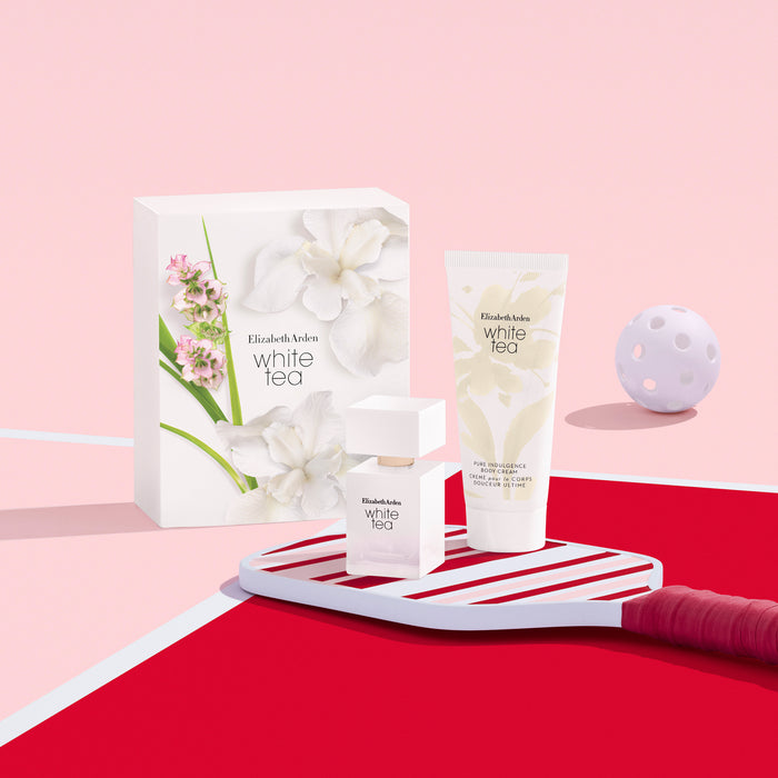 Elizabeth Arden White Tea skincare products on a pink and red background