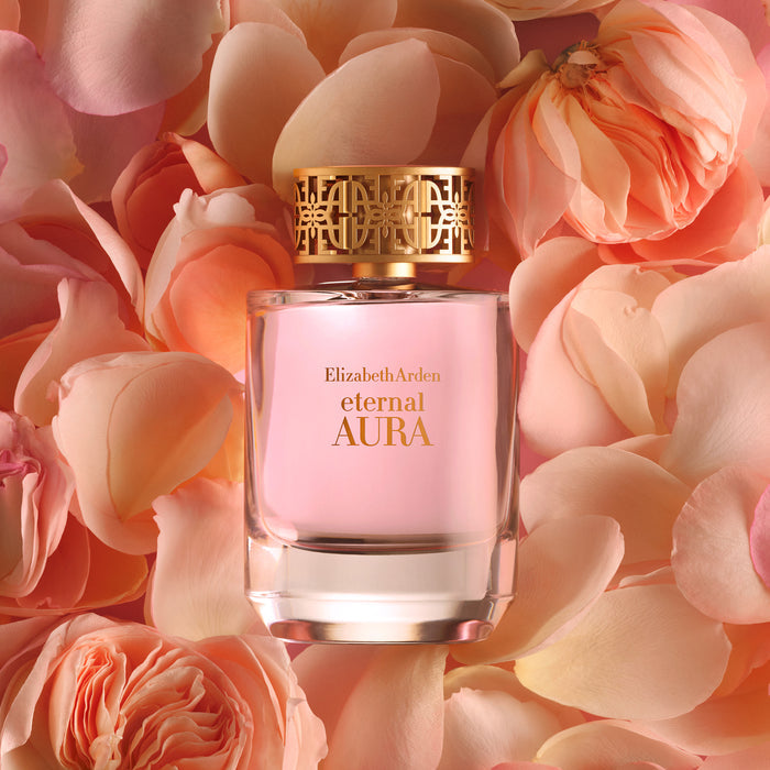 Eternal Aura Eau de Parfum bottle surrounded by soft pink rose petals