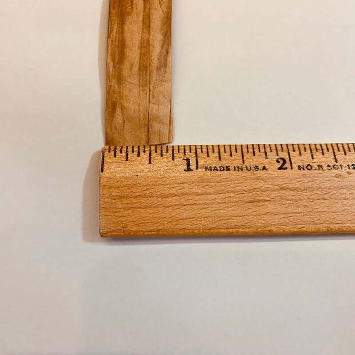 Strand of Fiber Splint placed next to a ruler to show the width of the material