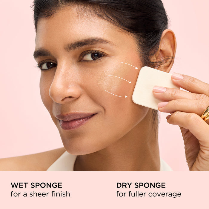 Woman applying a product with wet and dry sponges on a pink background