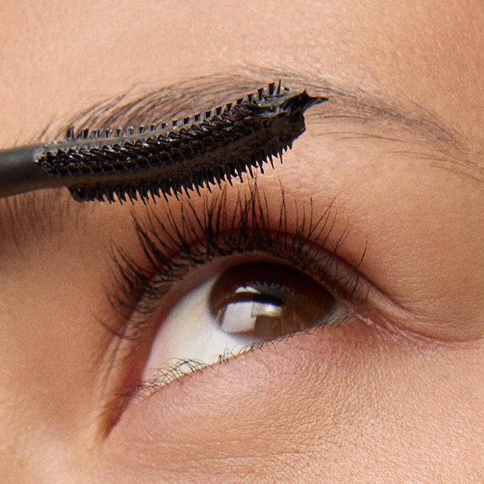 Close-up of an eye with mascara being applied