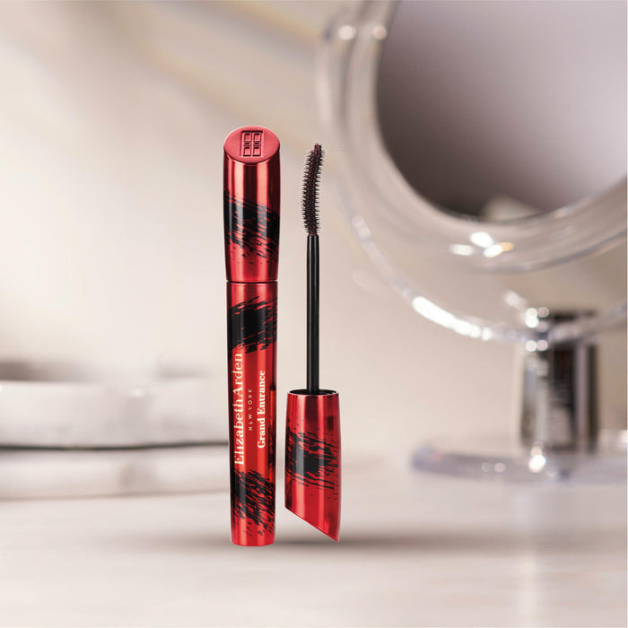 Red and black mascara with brush on a blurred bathroom counter background