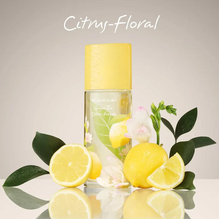 Elizabeth Arden perfume bottle with lemons and flowers on a reflective surface