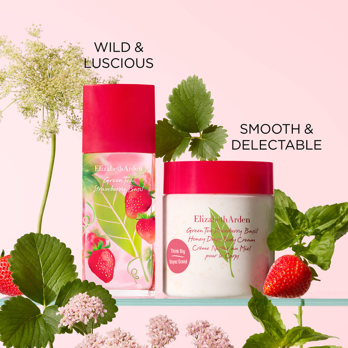 Green Tea Strawberry Basil body cream and fragrance set surrounded by strawberries and fresh green leaves
