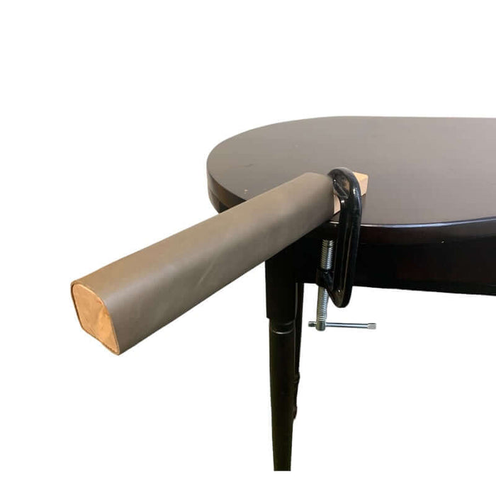 Large leather covered wooden hammer block attached to the table with a c-clamp.
