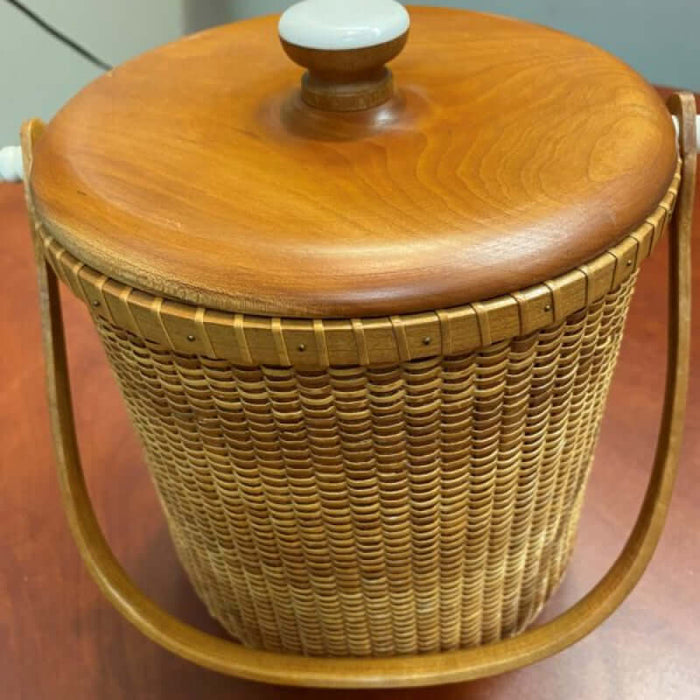 A round cherry handle attached to a 2 Qt Ice Bucket woven in the Nantucket style.