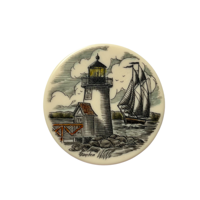 Nantucket basket scrim disc with lighthouse and schooner in the background on the water