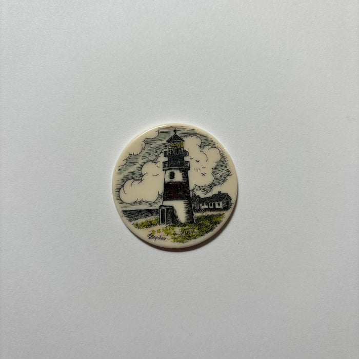 Nantucket Basket Scrim Disk with lighthouse, green grass, and house.