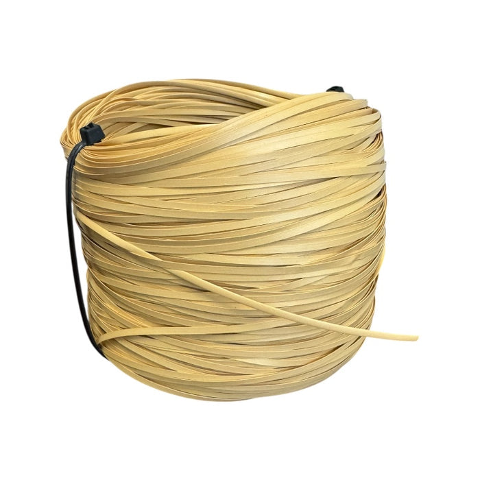 Large spool of new plastic strand cane for seat weaving on a white background