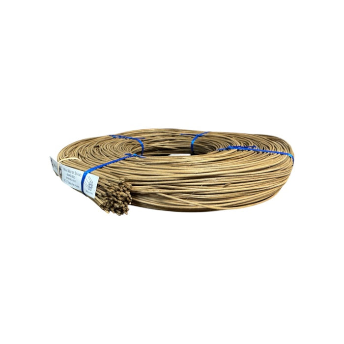 A coil of brown smoked round reed on a white background