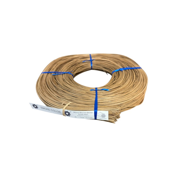 A coil of brown smoked round reed on a white background