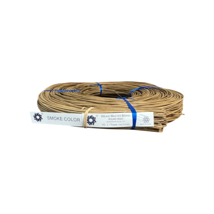 A coil of brown smoked round reed on a white background