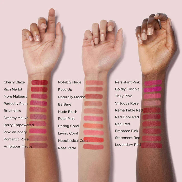 Three hands with various lipstick swatches on a pink background