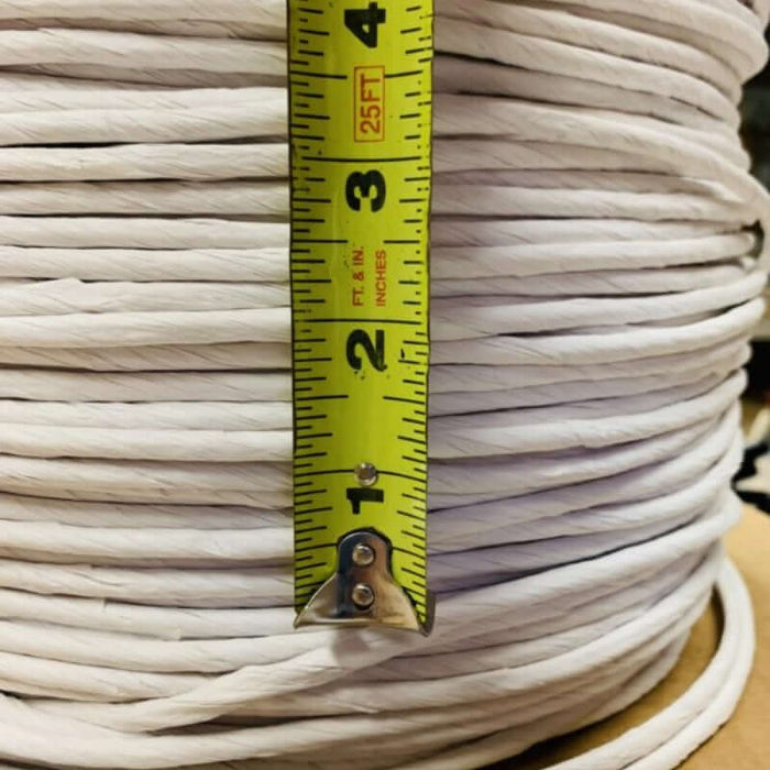 White Fiber Rush Reel with yellow ruler showing the size of each strand.